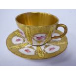 A Royal Doulton gilded china cabinet cup and saucer,