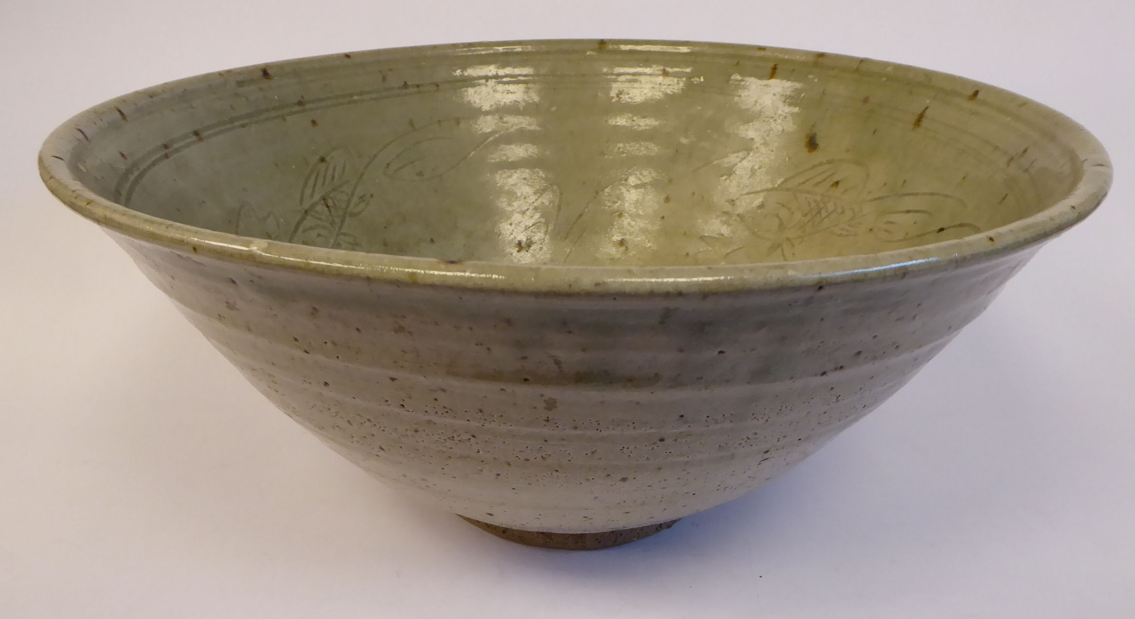 A pale green glazed studio pottery footed bowl,