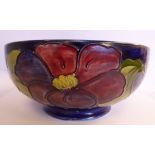 A Moorcroft pottery footed fruit bowl, decorated in tubeline in a version of the Anemone design,