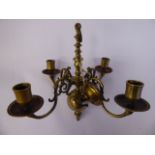 A 19thC Dutch brass chandelier, the four scrolled branches with candle sockets and wide drip pans,