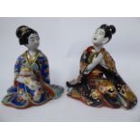 A late 19thC Japanese porcelain figure, a seated woman, wearing a colourful kimono,