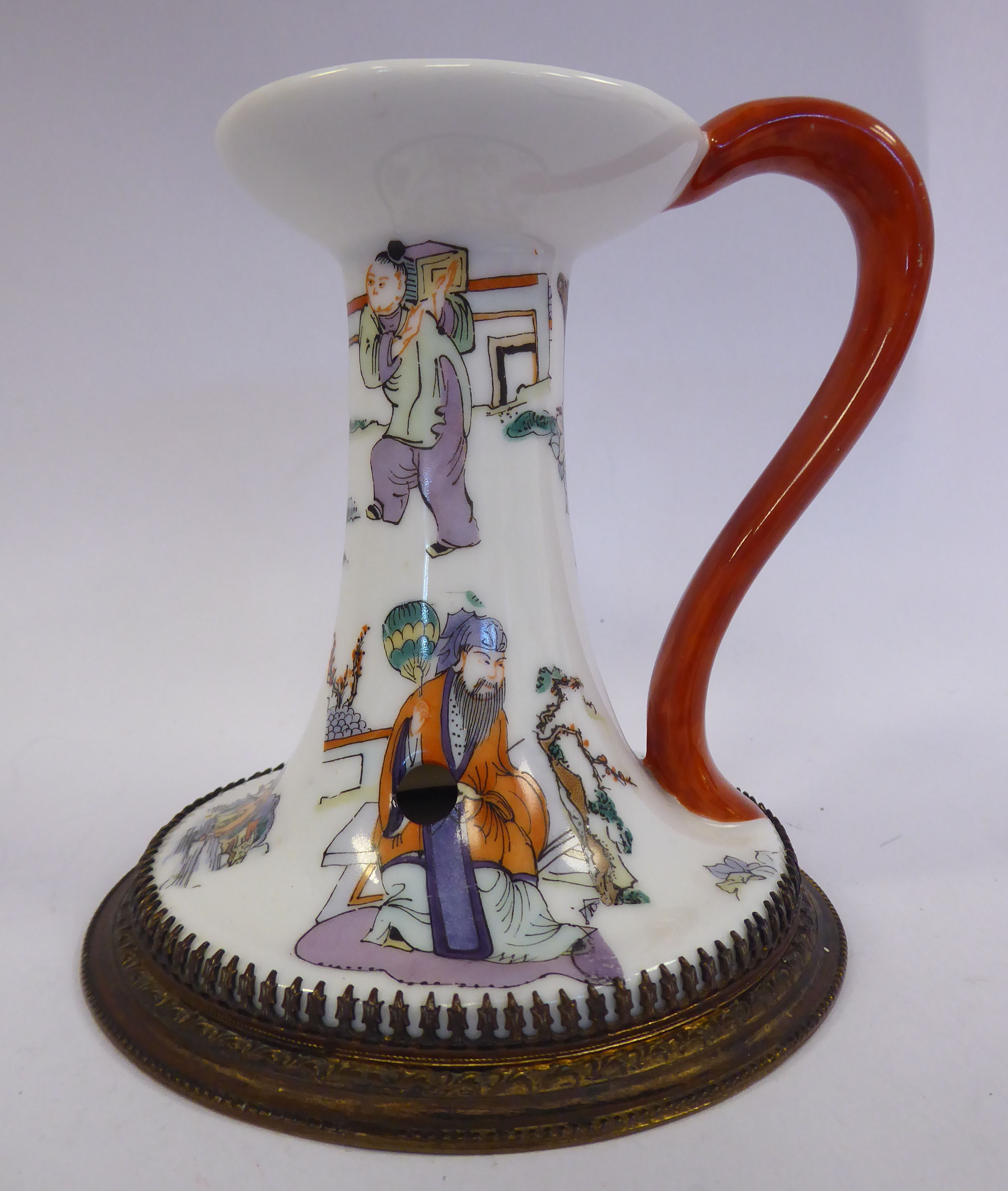 An early 20thC Chinese porcelain chamberstick of tapered form with a flared sconce and applied loop