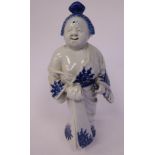 A late 19thC Chinese blue and white decorated porcelain figure, a standing, robed woman,