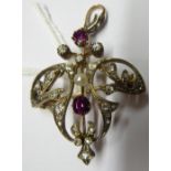 A bi-coloured gold foliate scrolled pendant brooch, claw set with two rubies,