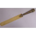 A late Victorian page turner, the ivory blade set into an ornately cast,