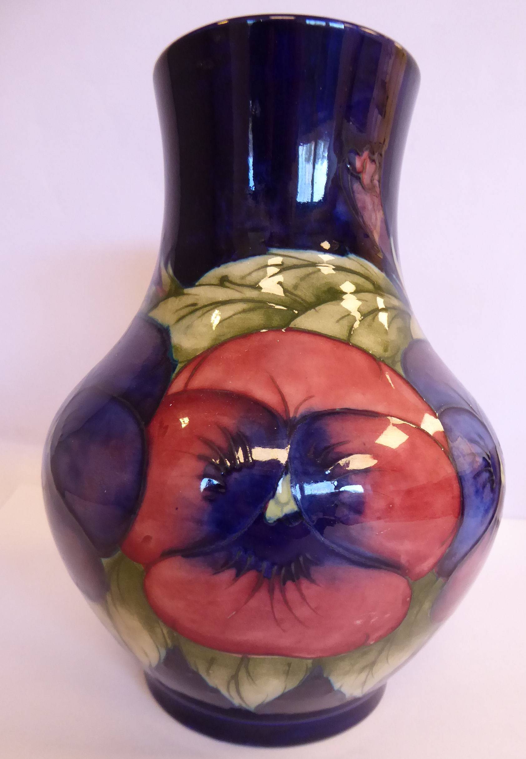 A Moorcroft pottery vase of bulbous form with a wide, upstand neck,