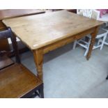 A modern waxed pine farmhouse style kitchen table with two frieze drawers,