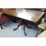 A George III oak tip-top pedestal table, the planked top with round corners,