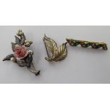 Three dissimilar white metal floral and other brooches 11