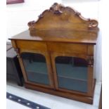 A mid Victorian mahogany chiffonier with a foliate carved, C-scrolled upstand,