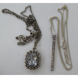 Two similar silver pendants, set with white stones,