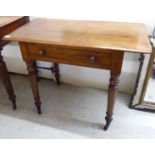 A late Victorian mahogany side table, the top over a frieze drawer,