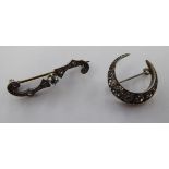 A silver crescent brooch; and an 'antique' example,