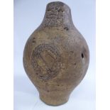 A 17th/18thC body of a stoneware bellarmine of ovoid form with the remains of a moulded mask and