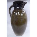 A modern green and brown glazed studio pottery ewer of ribbed,