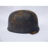 A German parachutist's helmet with a hide liner, chinstrap,