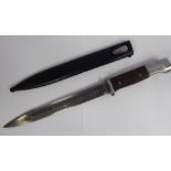 A German World War II bayonet, the stainless steel handle with two part hardwood grip,