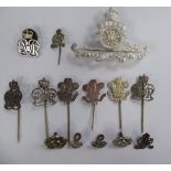 Various white metal military related insignia: to include stickpins and a Royal Artillery cap badge