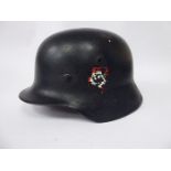 A World War II German helmet with a hide liner,