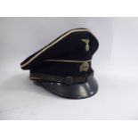 A German SS black visor cap with white piping,