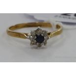 A 9ct gold claw set sapphire and diamond cluster ring 11