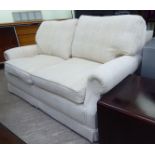 A Scotchguard two seater settee, upholstered in textured, patterned, cream coloured fabric,