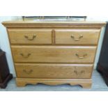 A modern light oak four drawer dressing chest,