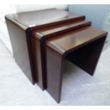 A nesting set of three modern Danish made rosewood finished occasional tables largest 18''h 20''w