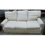 A Scotchguard three seater settee, upholstered in textured, patterned, cream coloured fabric,