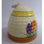 A Clarice Cliff pottery honey pot of tapered, ribbed form,