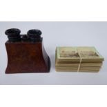 A late Victorian figured walnut cased handheld stereoscope with ebonised eyepiece surrounds;