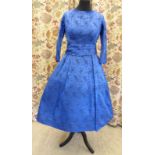 A mid 1950s blue taffeta cocktail dress, decorated with black flora,