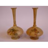 A pair of Royal Worcester blush ivory glazed china bottle vases of squat, bulbous form, having long,