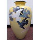 An early 20thC Japanese cloisonne vase of baluster form, decorated with birds in flight,