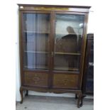 An Edwardian satinwood inlaid mahogany display cabinet with two glazed doors,