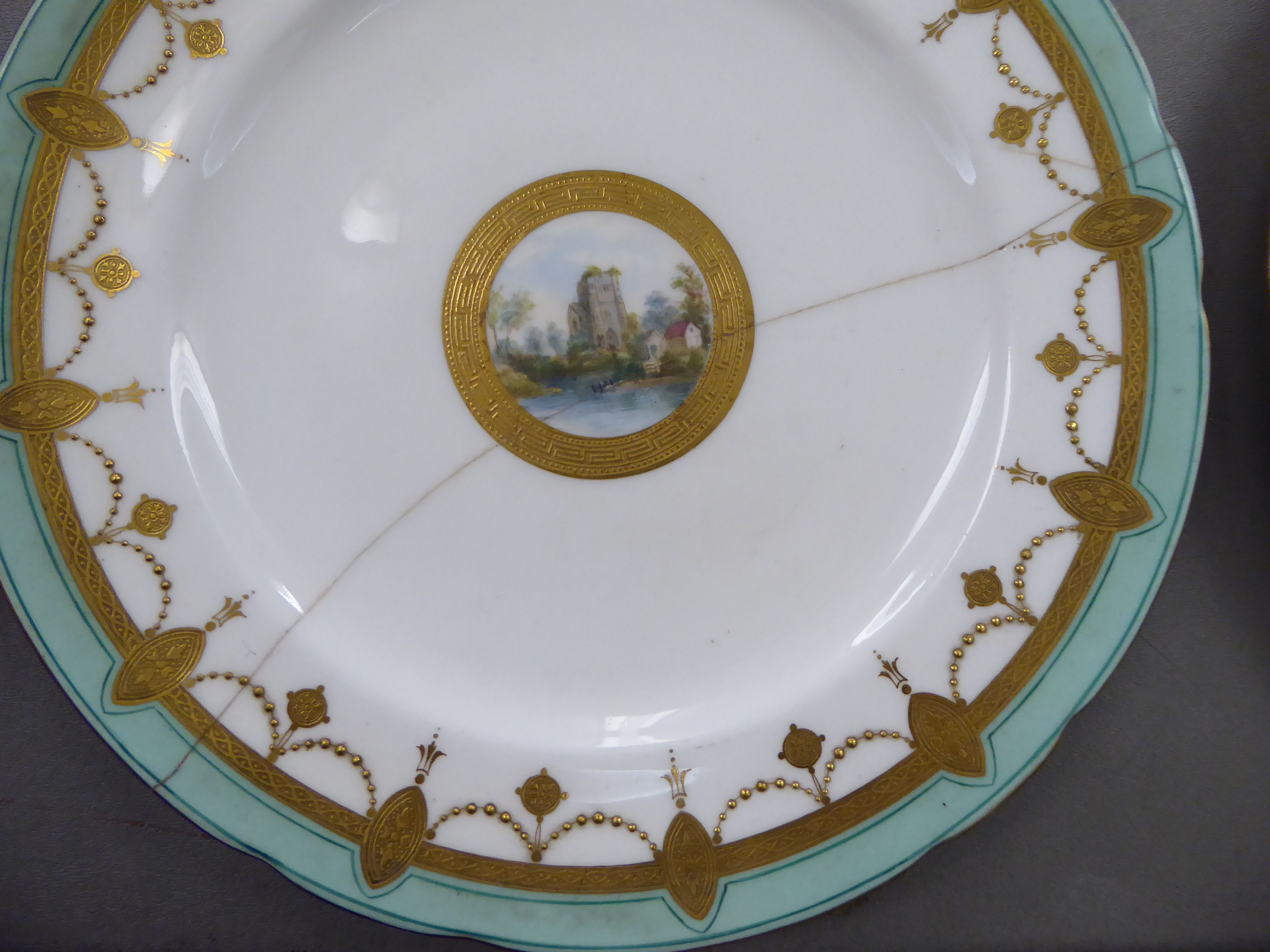 An early 20thC Minton porcelain dessert service, decorated with landscapes, cartouches, - Image 6 of 7