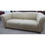 A modern brown and cream coloured fabric upholstered two person settee with a level back and