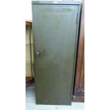 A modern green painted steel storage cabinet with a lockable full-height door,