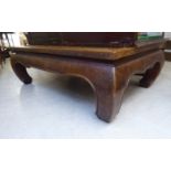 A late 19th/early 20thC Chinese stained hardwood coffee table of traditional form, raised on block,