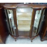 An Art Deco walnut and mahogany finished breakfront display cabinet with a glazed front,