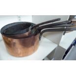 A graduated set of four mid 19thC copper saucepans with rivetted iron handles 9''-12''dia