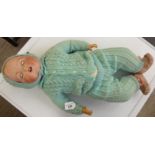 An Armand Marseille bisque head doll with weighted sleeping eyes and a fabric body,
