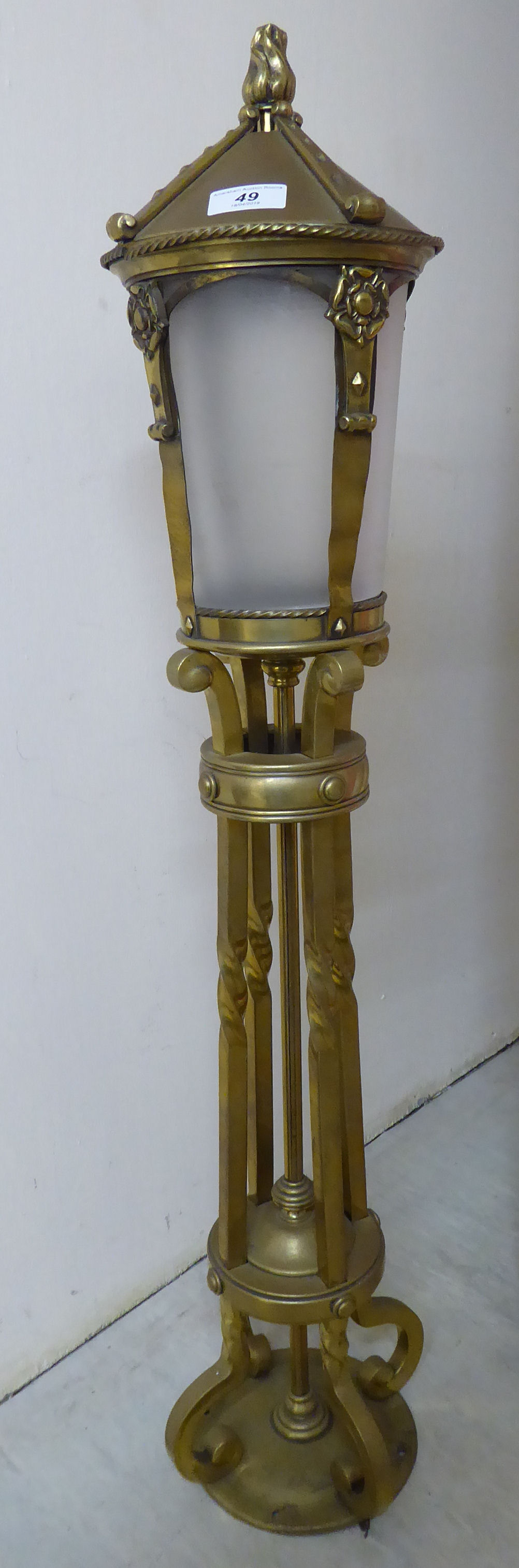 A modern brass framed freestanding lamp,