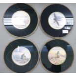 A set of four glazed place mats with studies of gamebirds in the wild,