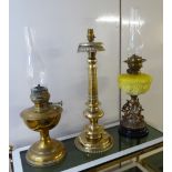 A late 19thC brass table lamp with a bowl shaped reservoir 12''h excluding the glass chimney;