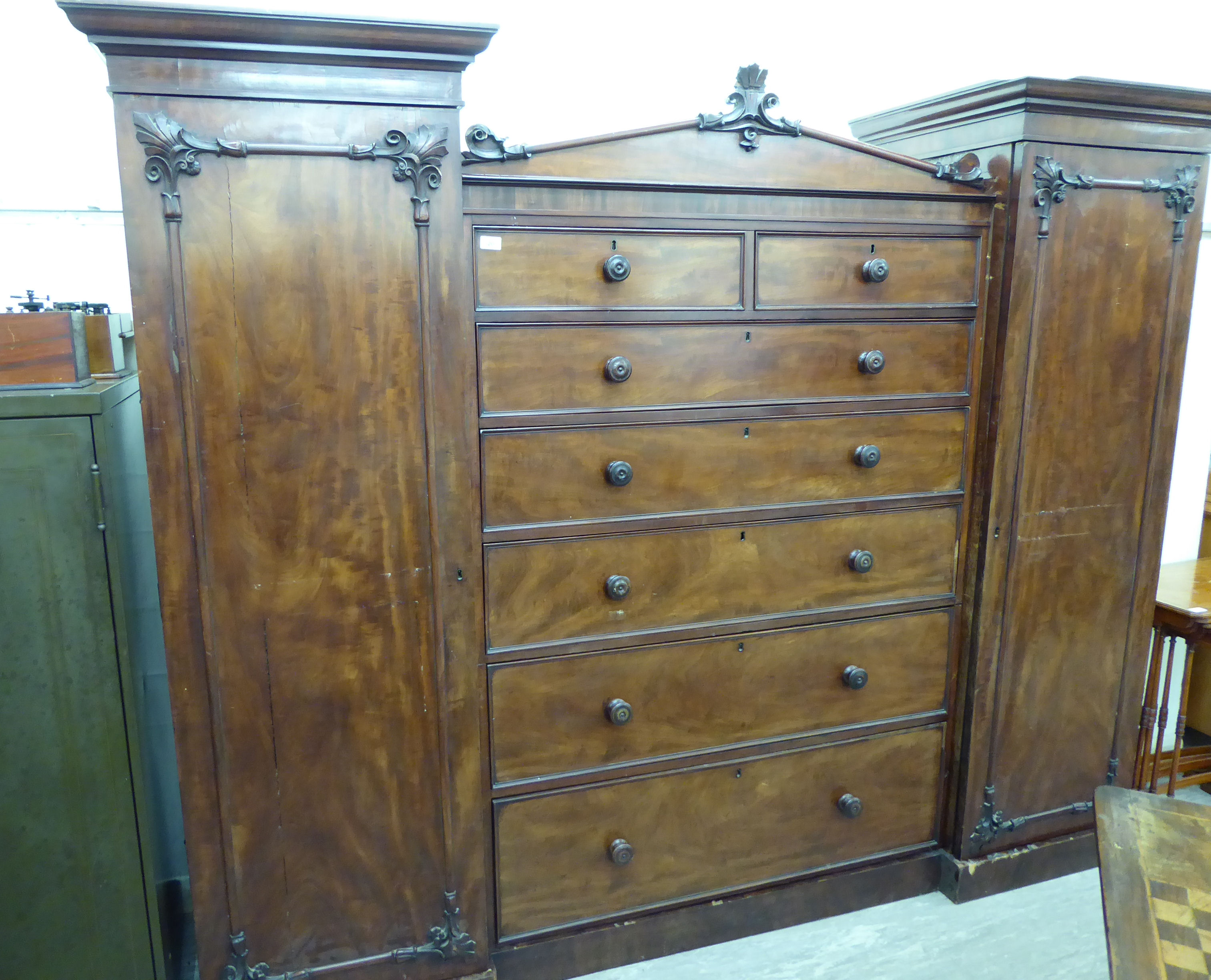 A late Victorian/Edwardian nine section triple wardrobe with a central back of two short/five long