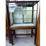 An early 20thC confectionary retailer's mahogany display cabinet with a pair of sliding glazed rear