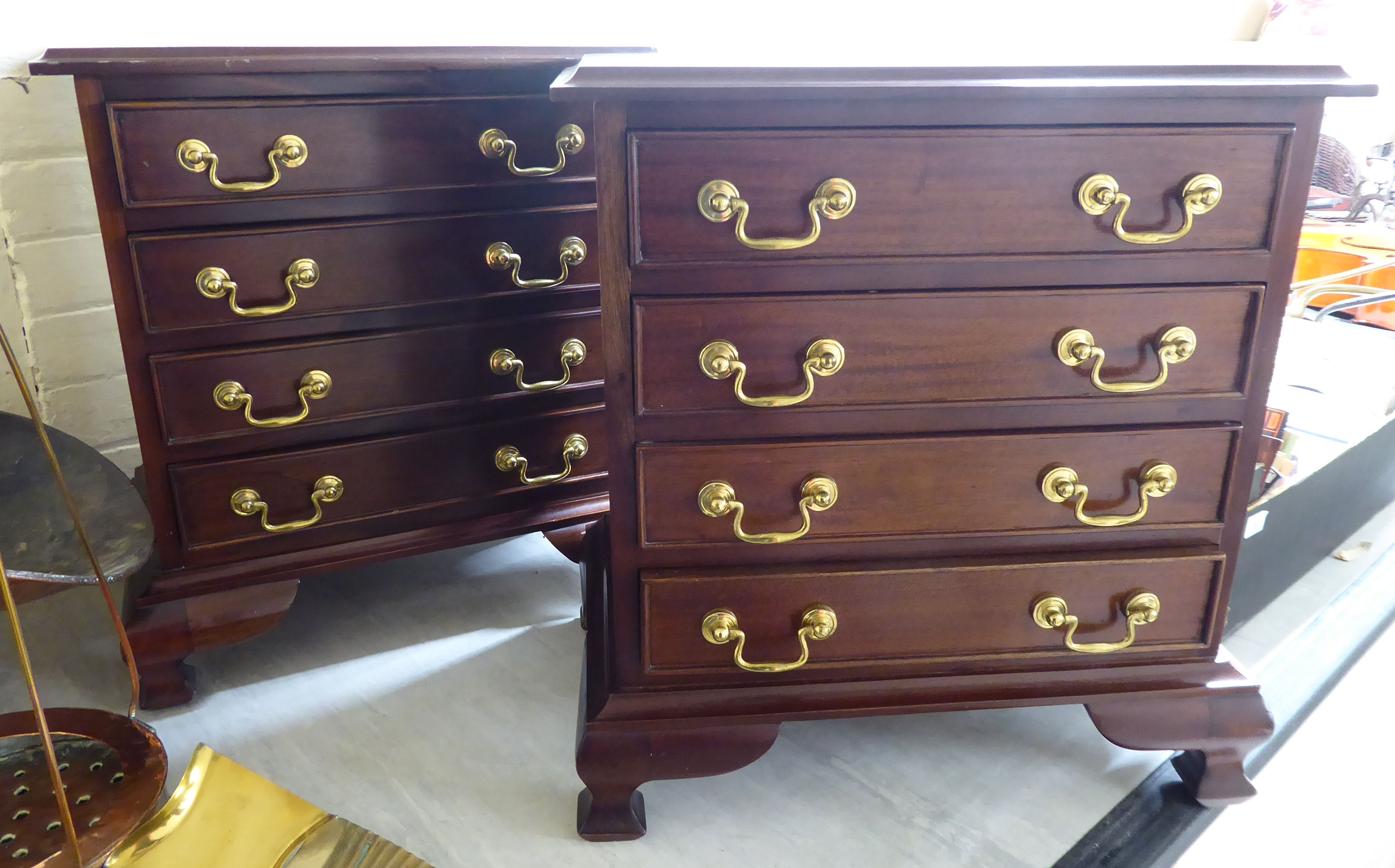 A pair of modern mahogany four drawer beside chests with brass bail handles,