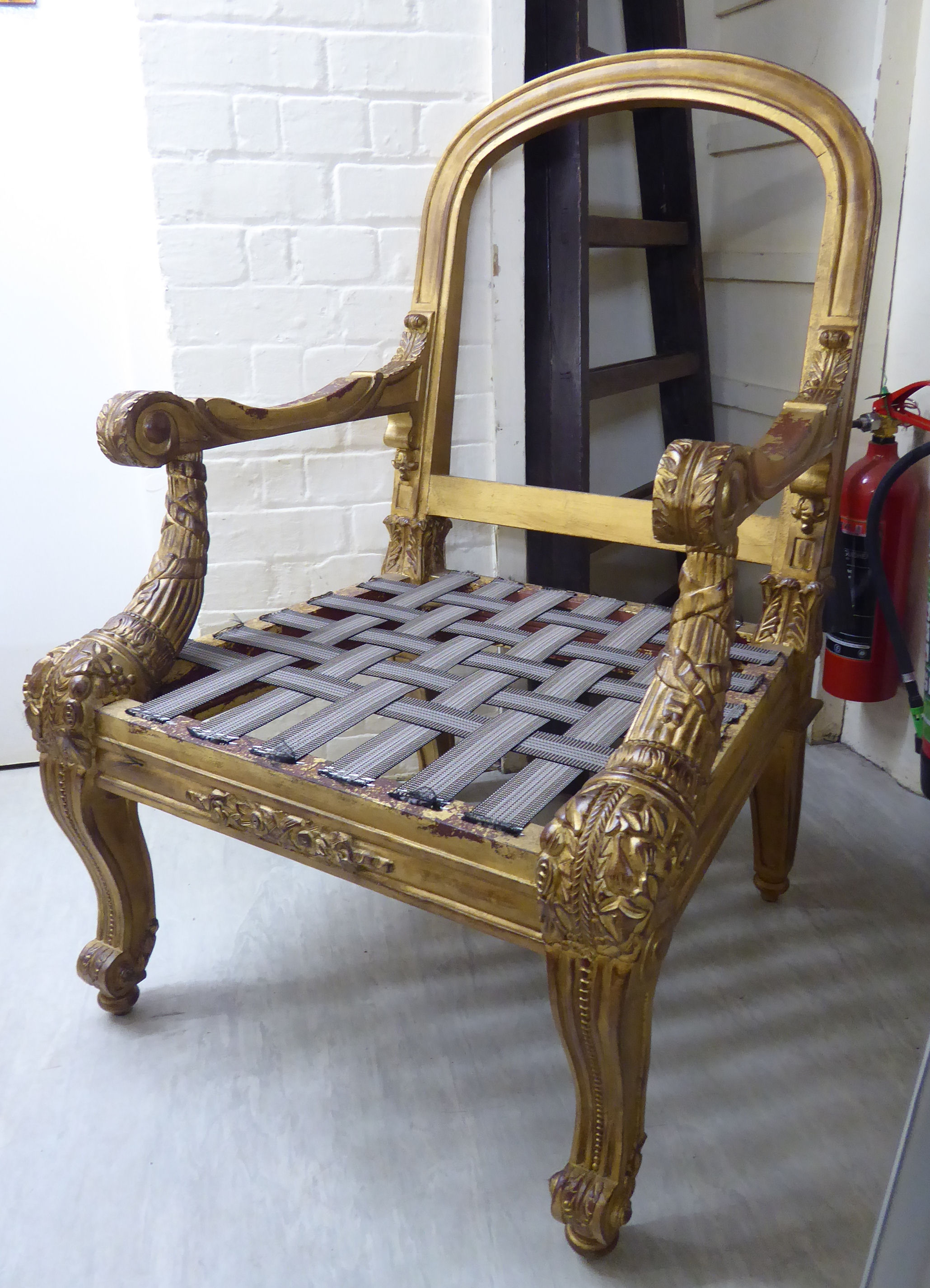 A Ralph Lauren 'Duke' gilt sprayed showwood open arm chair frame,