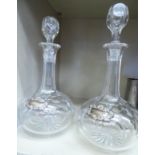 A pair of early/mid 20thC cut glass decanters with stoppers;